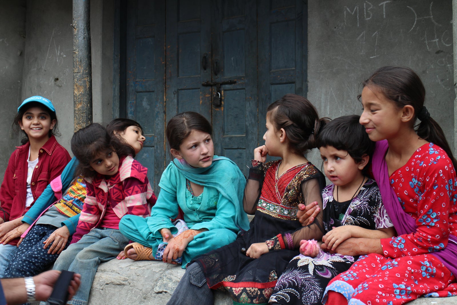 Girls sitting together outside a classroom